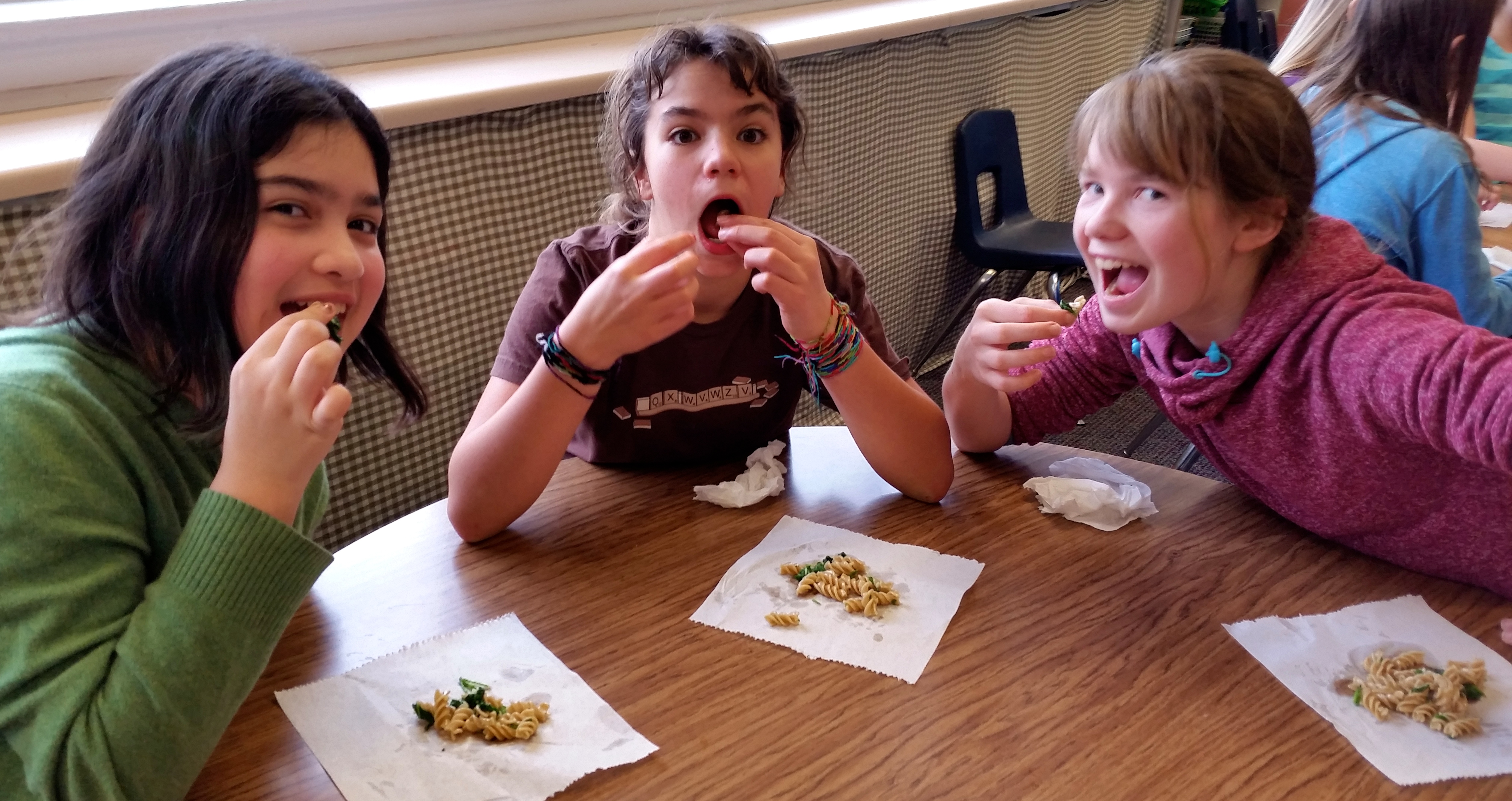 Happy students enjoying stinging nettle pasta. Seconds please!